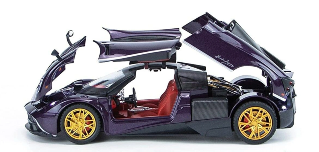 Model of a futuristic sports car with open doors on a white background